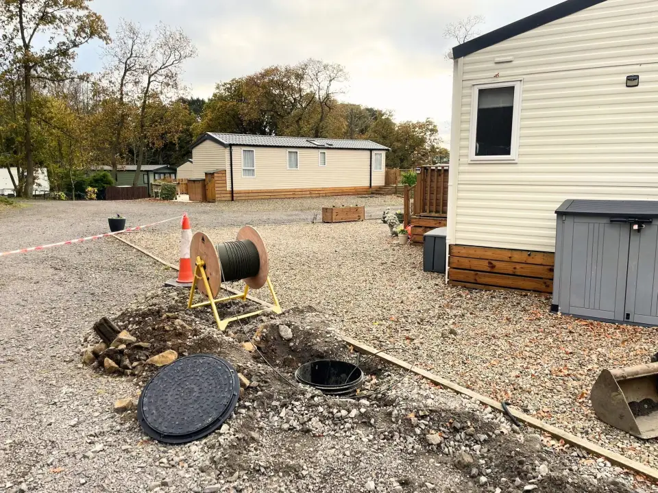Fibre drum and new duct chamber between static caravans at Fallowfield Dene Caravan Park