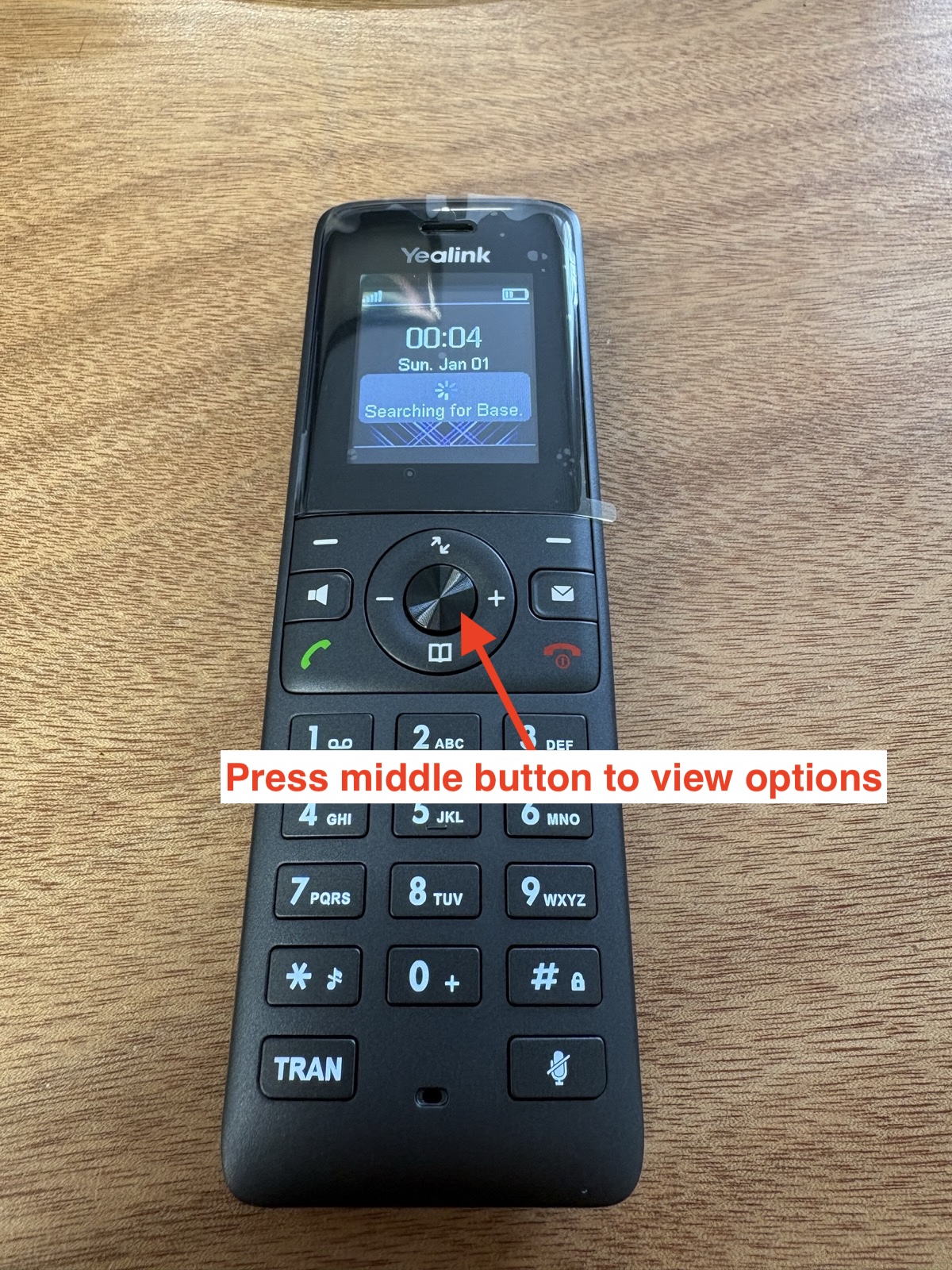 Yealink handset showing the middle button used to open the options menu